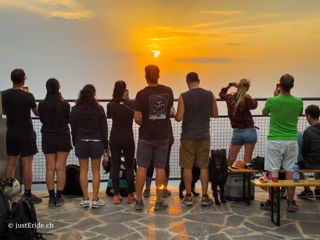 Outdoor group aperitivo during the Eclipse 2026 sunset event on Monte Generoso, organized by justEride.ch and wannawake.ch.